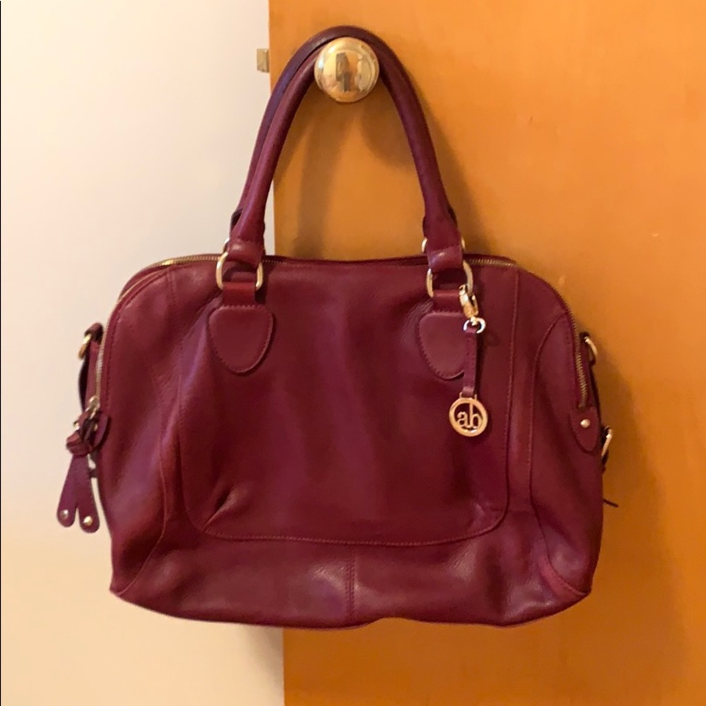 Maroon purse with gold accents